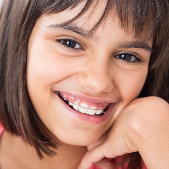 Smiling girl with orthodontic appliance
