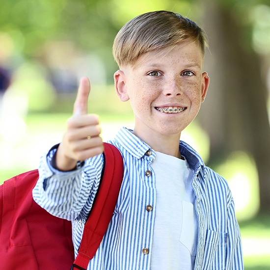 Teen boy with dentofacial orthopedics smiling