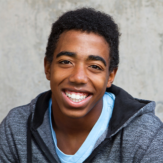 Teen with healthy smile after orthodontic treatment