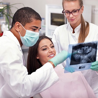 Holliston orthodontist explaining X-ray to patient