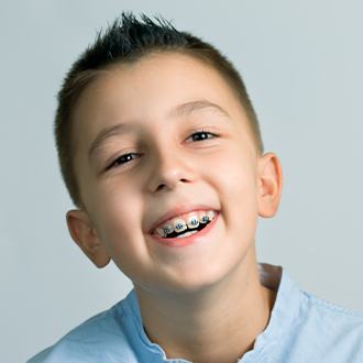 Young boy with pediatric orthodontics smiling