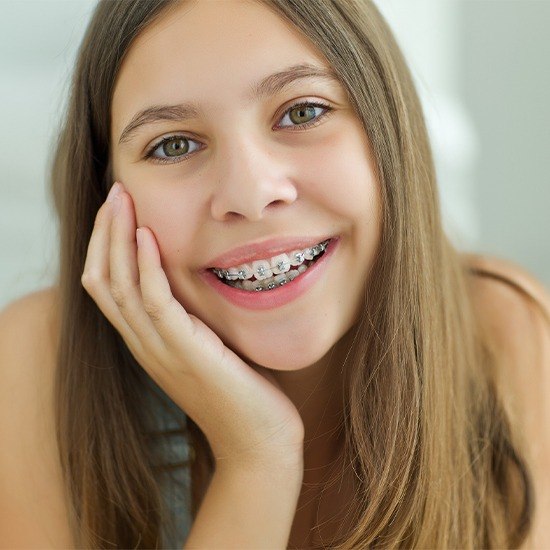 Teen with self ligating braces smiling