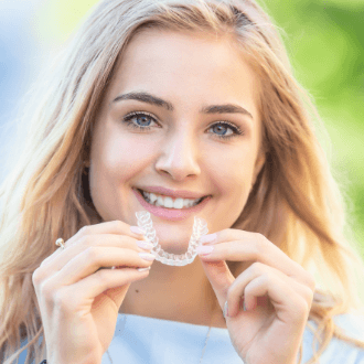Young woman placing an Invisalign tray