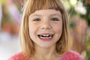 Smiling little girl with pediatric orthodontics in Holliston