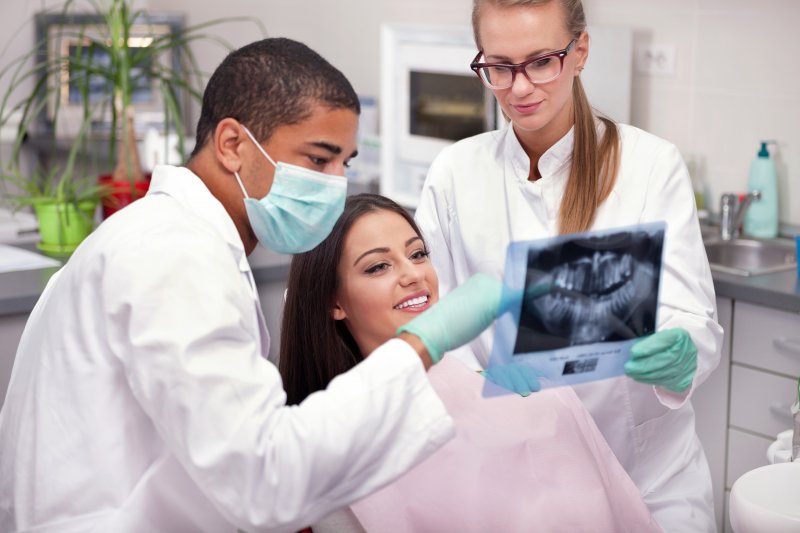 Orthodontist showing patient X-ray of their teeth