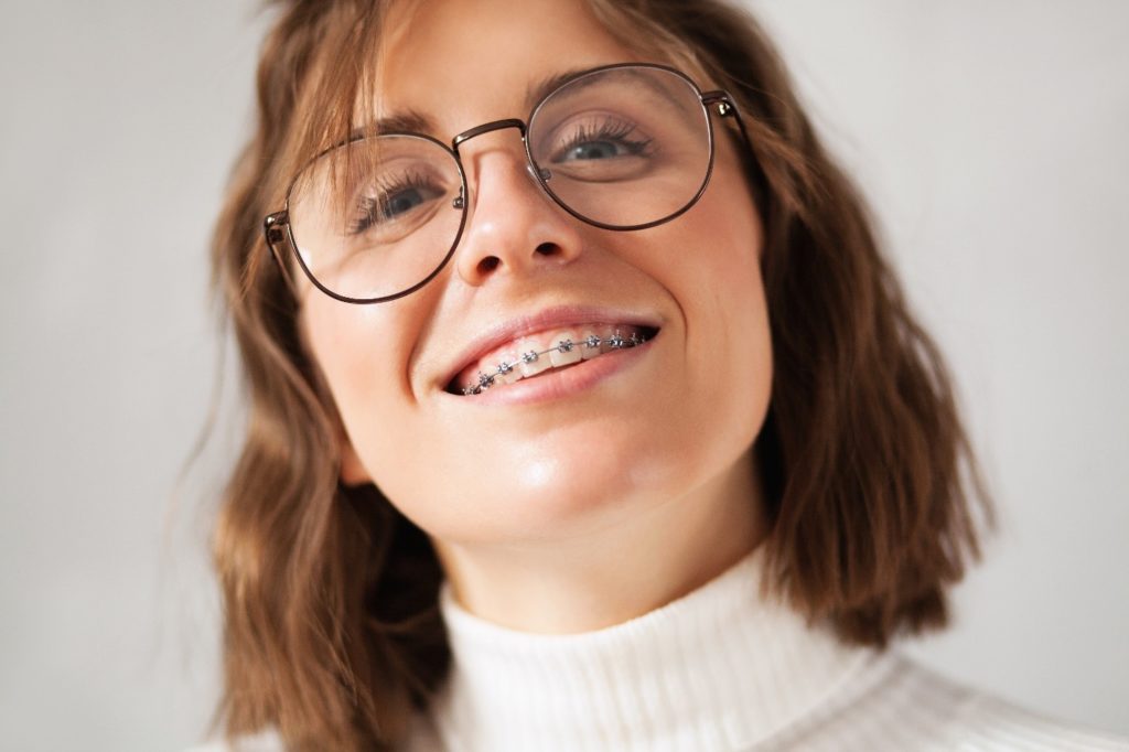 Closeup of woman with traditional braces smiling