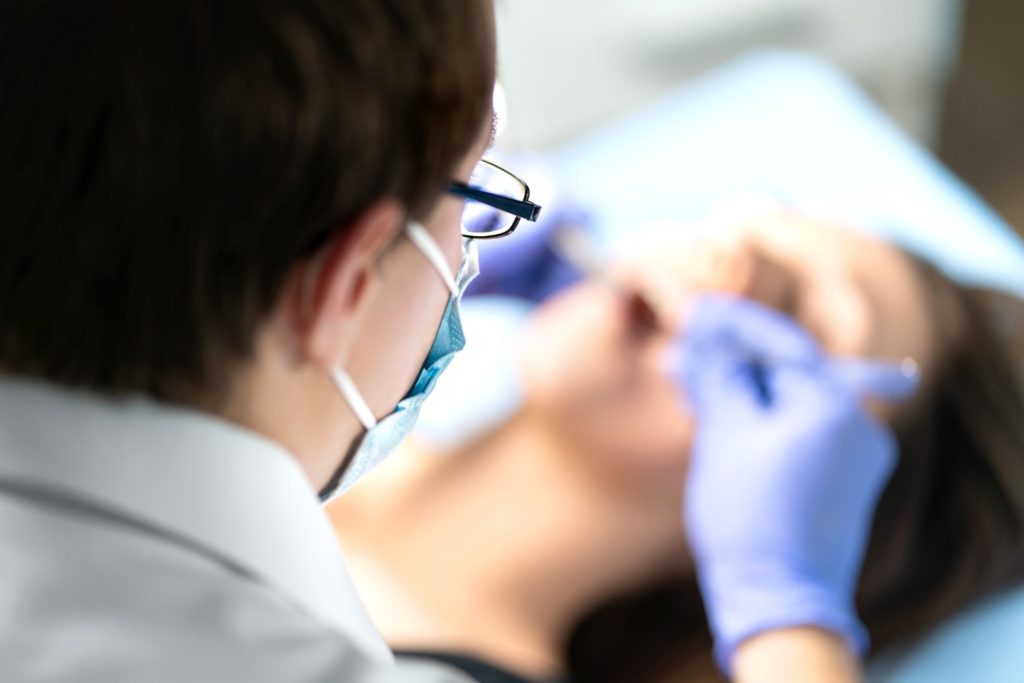 Orthodontist conducting braces removal