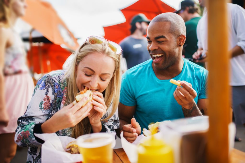 Couple smiling while enjoying meal