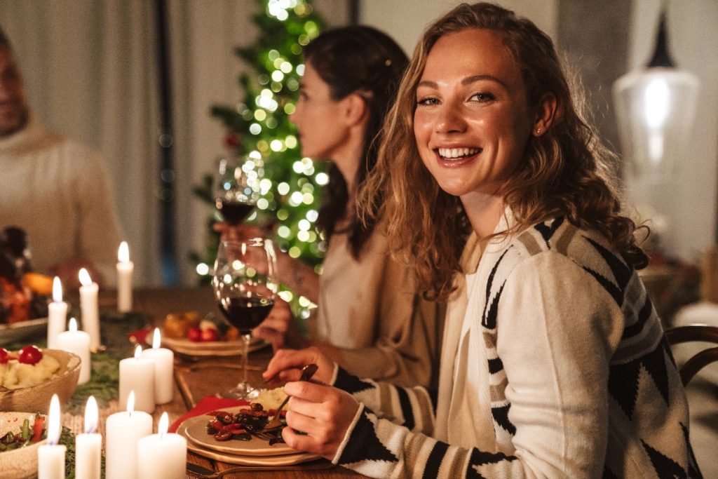 Woman with straight teeth smiling at Thanksgiving table